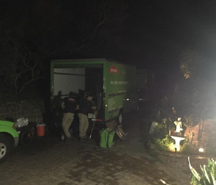 people loading cargo truck in middle of night
