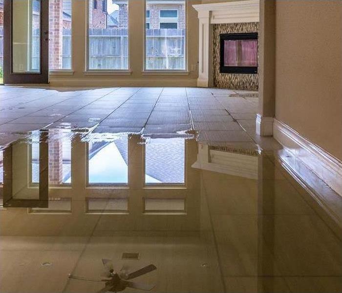 puddle of water on white tile flooring 