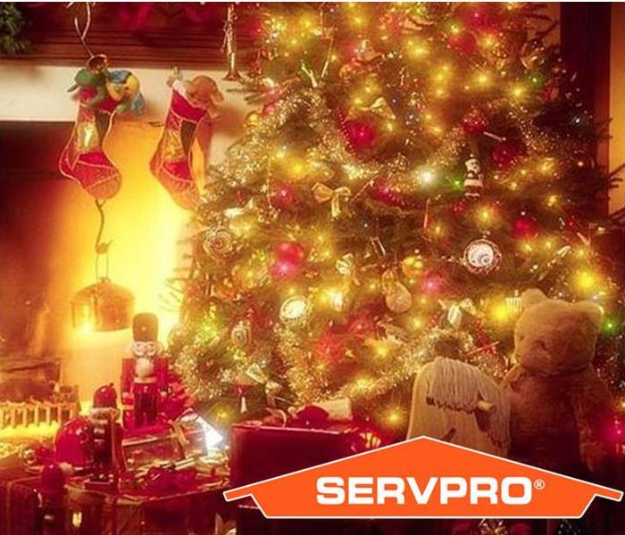 Christmas tree, stockings and a fire with SERVPRO logo.