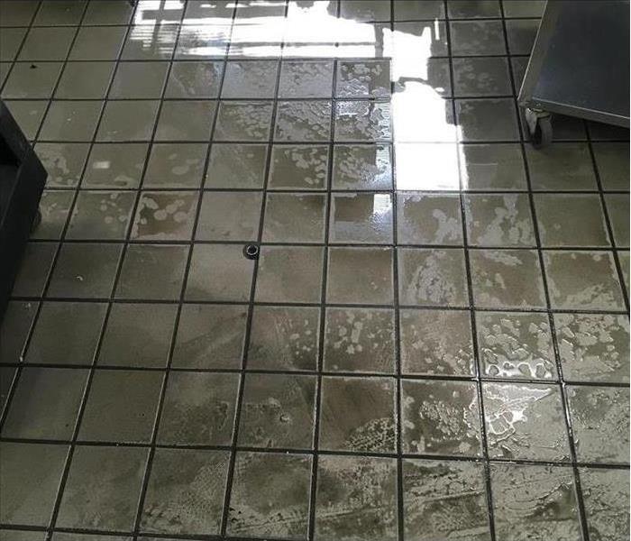 large puddle of water on tile flooring in a kitchen